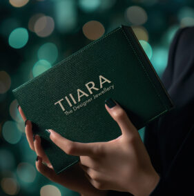 A sleek leather box in deep forest green with a subtle embossed texture, being carefully held by a poised model. The box has metallic accents on the edges, showcased under diffused studio lighting. The background is a rich, blurred bokeh effect, emphasizing the premium feel. Hyper-detailed, cinematic composition, ultra-luxury vibes --ar 4:5 --v 6 Job ID: 7ecf2b1f-1b43-4db8-8036-776f276734a2